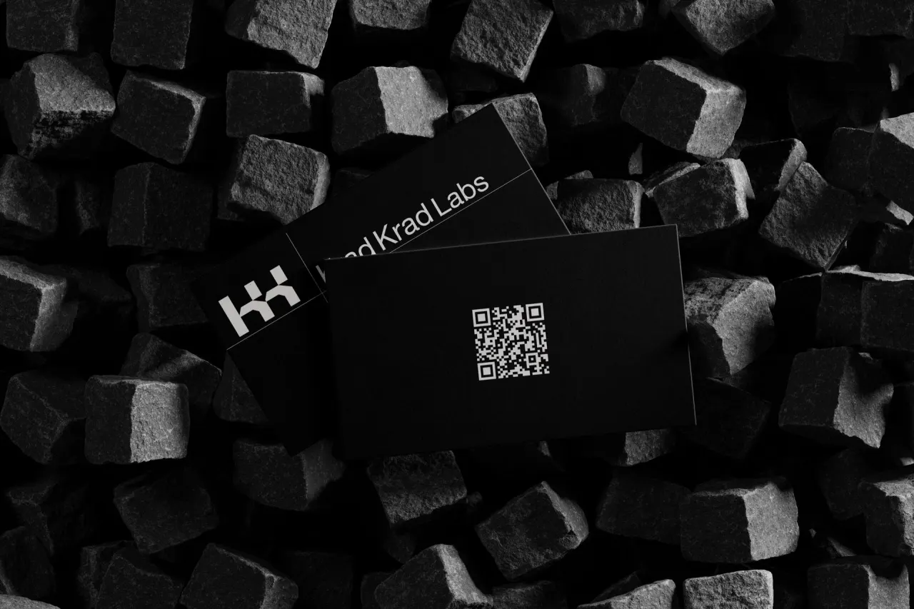 Black cards with a QR code on black stone cubes