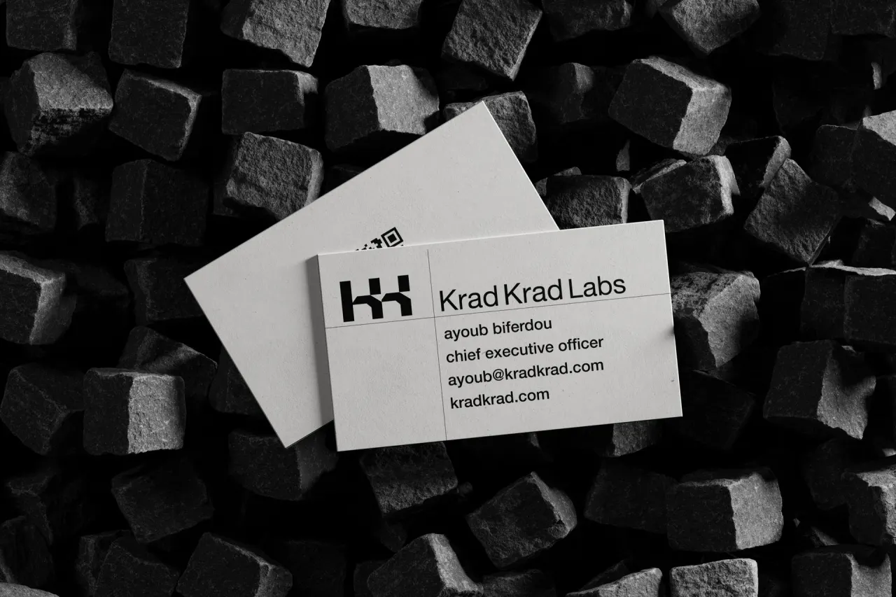 White Krad Krad Labs cards on black stone cubes