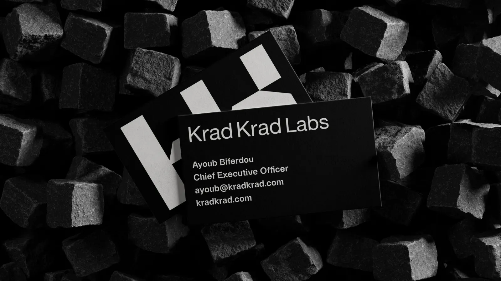 Black Krad Krad Labs business cards on black stone cubes