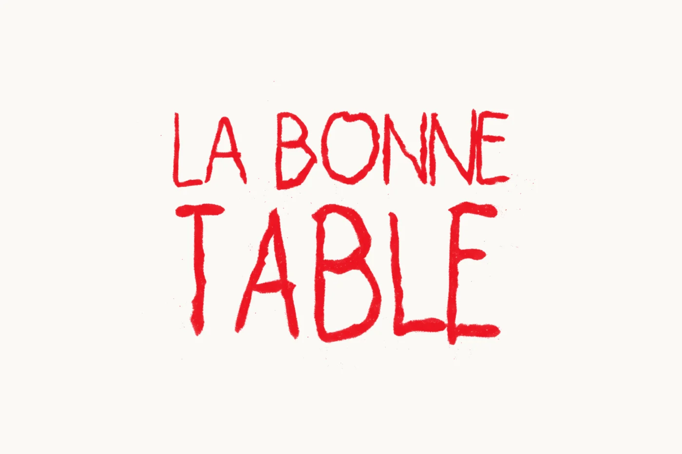 The La Bonne Table logotype in red pastel on white paper, on two lines