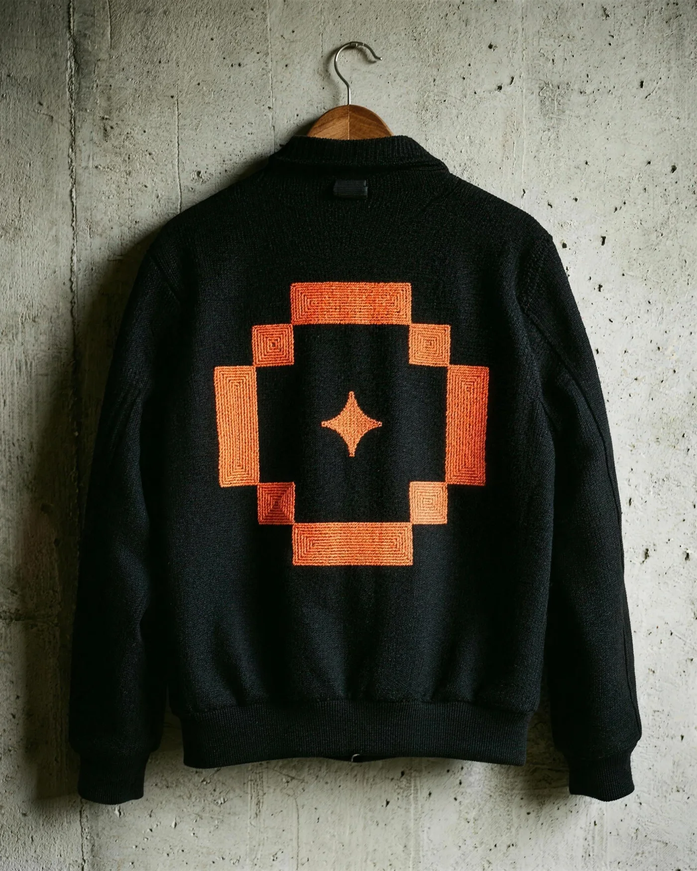 Black jacket with the orange emblem embroidered on the back