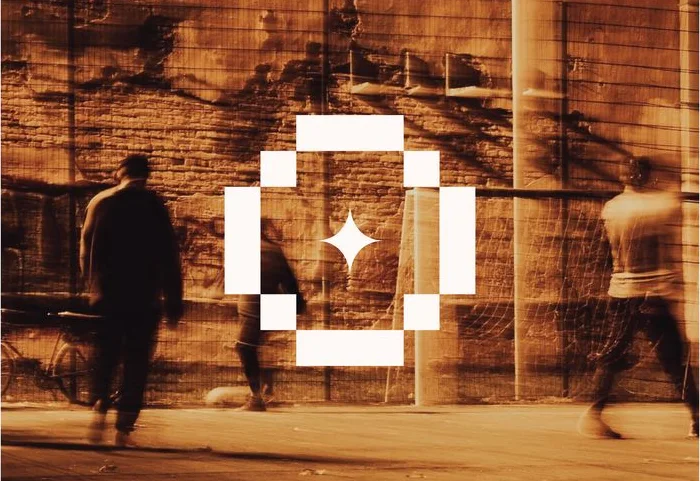 The emblem in white over an orange-toned street photograph