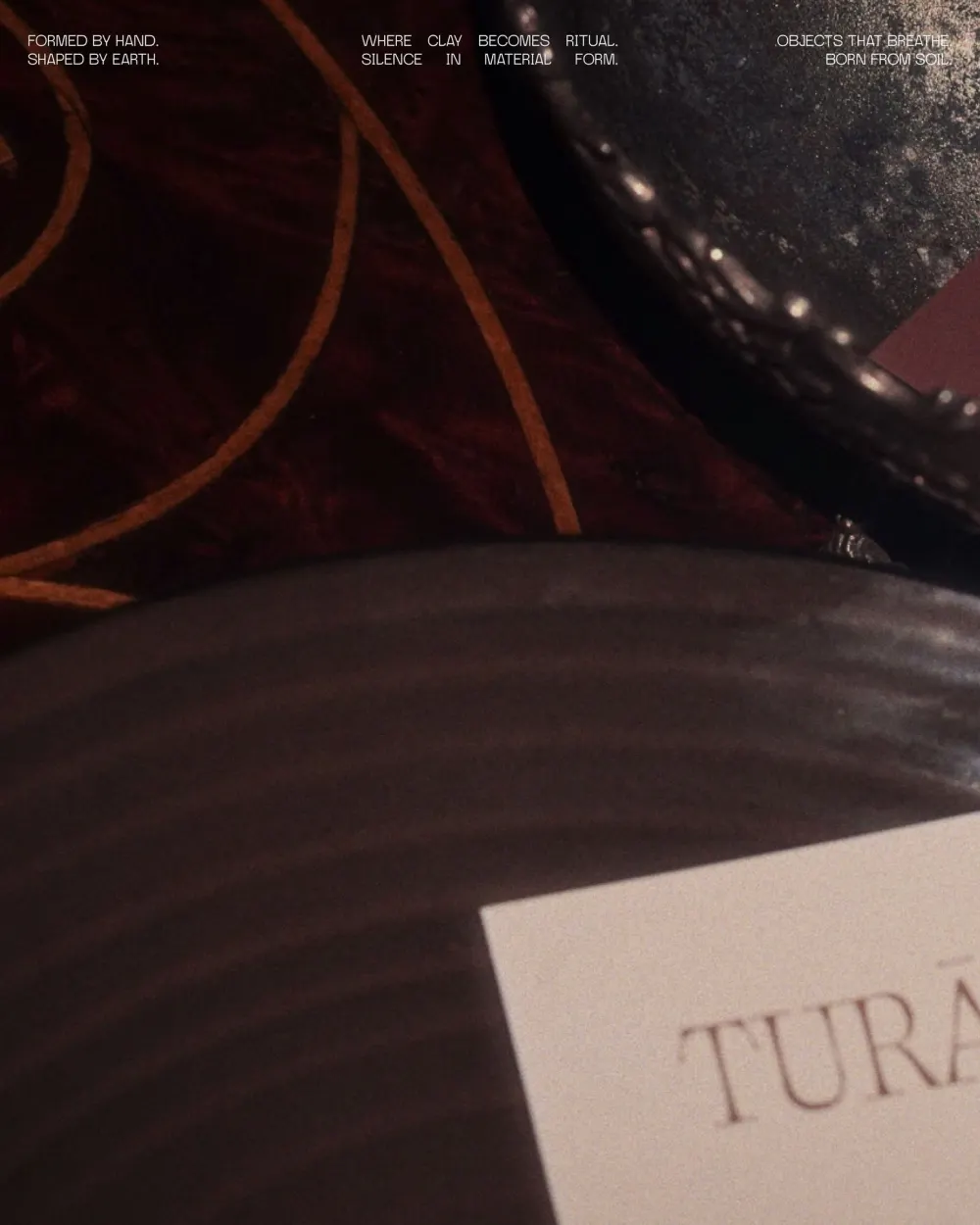 Close-up of stoneware with the three Turāb taglines